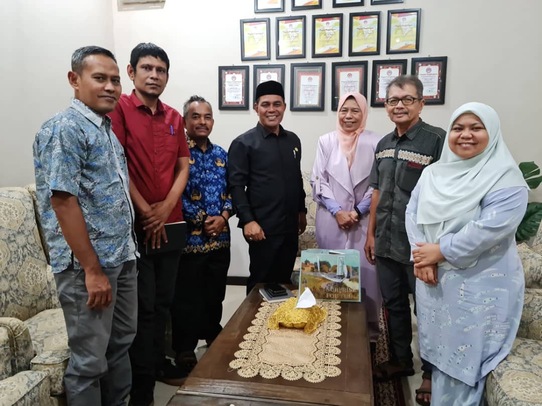 Handshake between business partners with contract signing ceremony in background