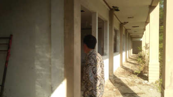 3D rendering of modern high-rise building with glass façade and complex geometric shapes